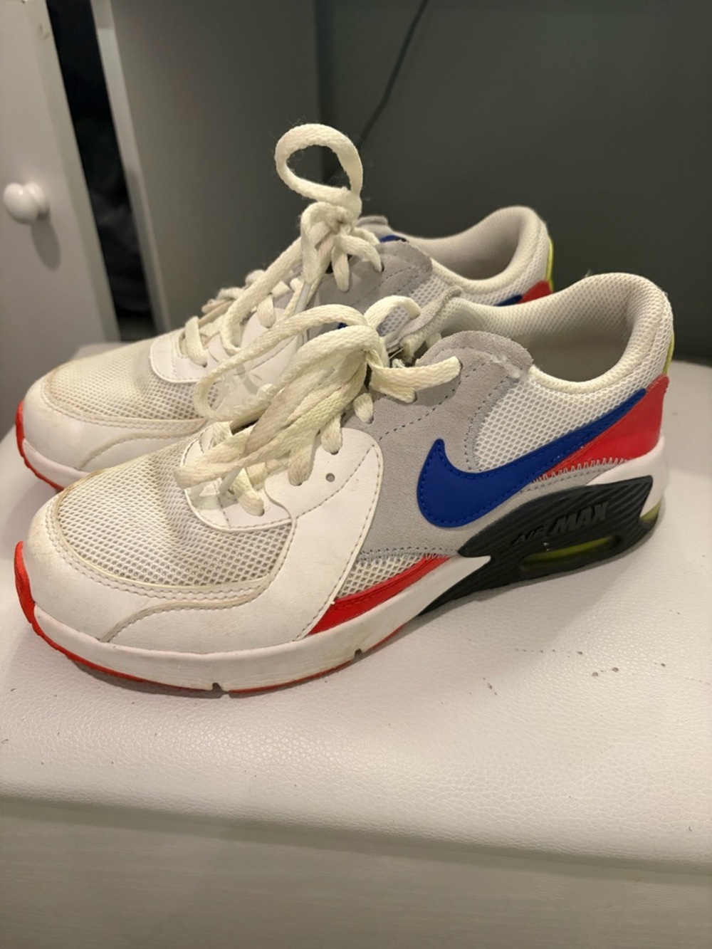 Nike Kids White Sneakers with Blue Swoosh and Red Accents